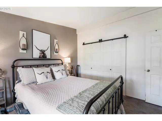 a bedroom with a bed and a mirror