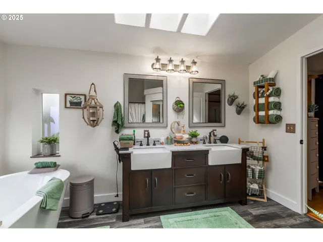 a bathroom with a double vanity sink mirror and toilet