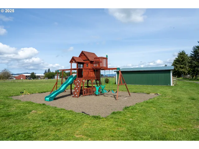 a view of a park with swings and a slide