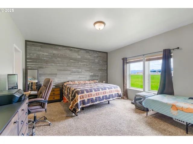 a bedroom with a bed a table and chair