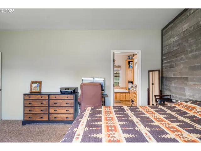 a bedroom with a bed and a dresser