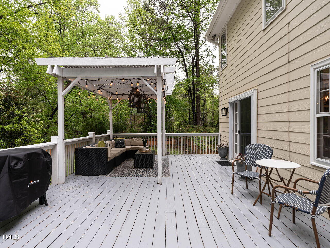 8805 Stage Ford Road Raleigh, NC 27615 - Photo 33 of 45 The charming Pergola lit with string light defines a seating area.
