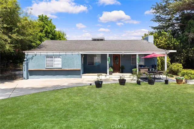 a view of a house with backyard porch and sitting area