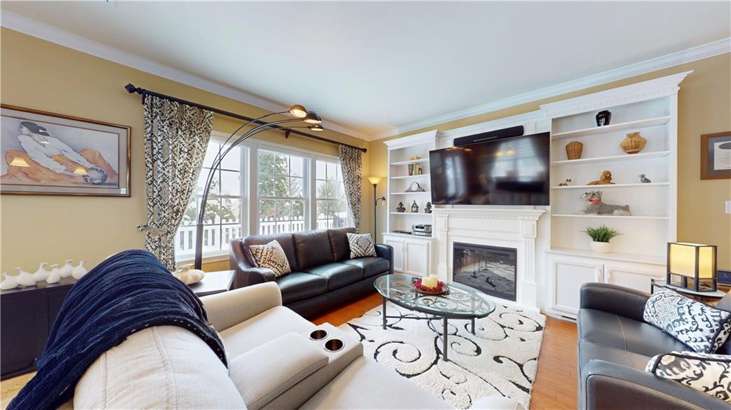 527 Pioneer Lane Freedom, PA 15042 - Photo 11 of 39 a living room with furniture a flat screen tv and a fireplace