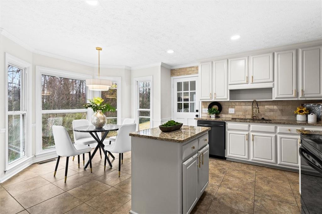 1101 Steeple Run Lawrenceville, GA 30043 - Photo 18 of 70 a kitchen with stainless steel appliances granite countertop a table and chairs in it