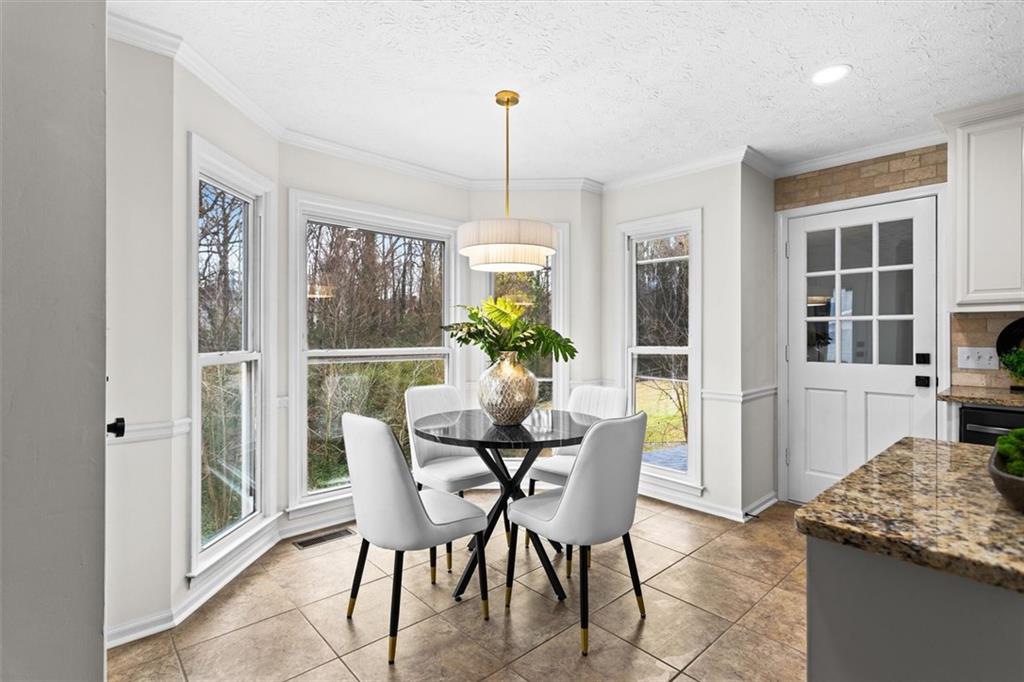 1101 Steeple Run Lawrenceville, GA 30043 - Photo 25 of 70 a dining room with furniture a chandelier and window