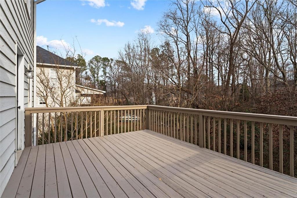 1101 Steeple Run Lawrenceville, GA 30043 - Photo 31 of 70 a balcony with wooden floor and fence
