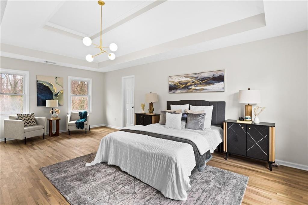 1101 Steeple Run Lawrenceville, GA 30043 - Photo 40 of 70 a spacious bedroom with a bed a couch and a chandelier