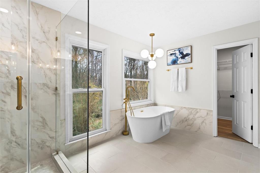 1101 Steeple Run Lawrenceville, GA 30043 - Photo 46 of 70 a spacious bathroom with a bathtub and shower