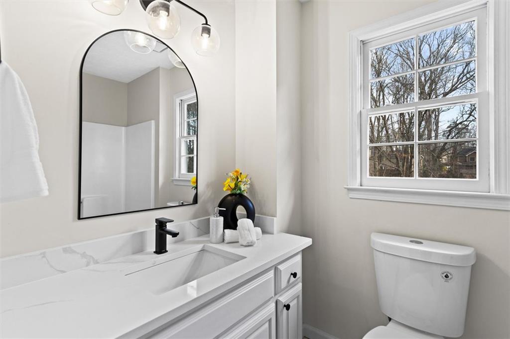 1101 Steeple Run Lawrenceville, GA 30043 - Photo 48 of 70 a bathroom with a toilet sink and mirror
