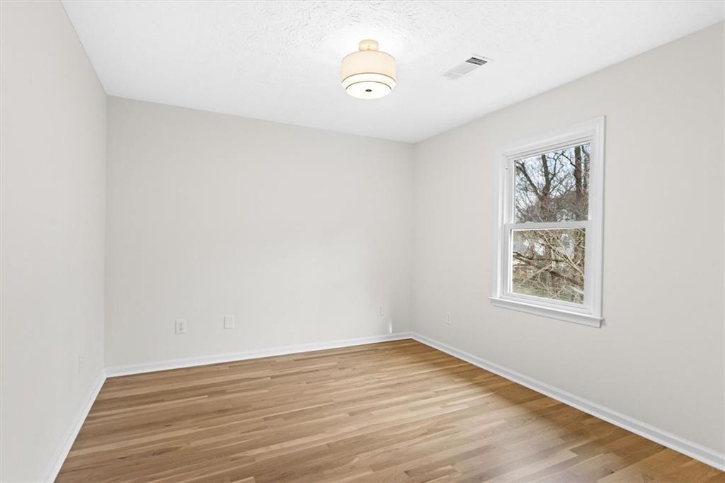 1101 Steeple Run Lawrenceville, GA 30043 - Photo 50 of 70 an empty room with wooden floor and window
