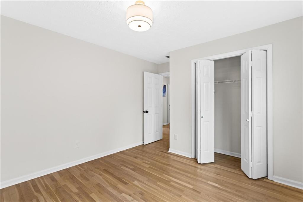 1101 Steeple Run Lawrenceville, GA 30043 - Photo 53 of 70 a view of an empty room with wooden floor