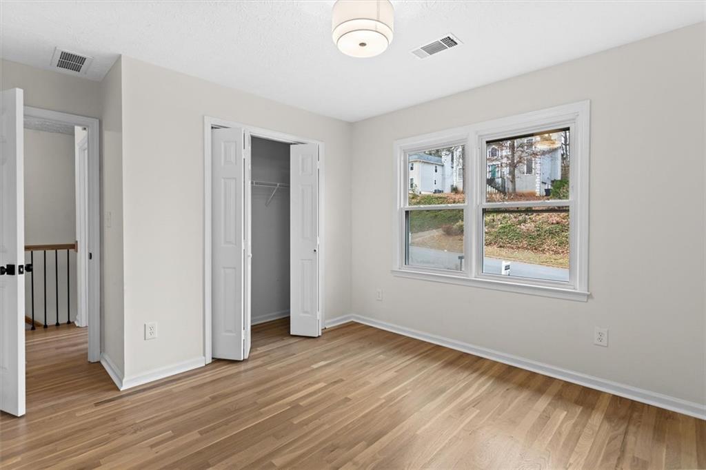 1101 Steeple Run Lawrenceville, GA 30043 - Photo 54 of 70 a view of an empty room with wooden floor and a window