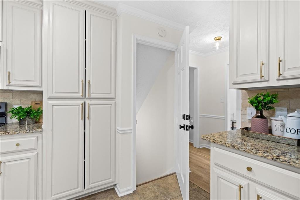 1101 Steeple Run Lawrenceville, GA 30043 - Photo 56 of 70 a bathroom with a granite countertop sink and white cabinets