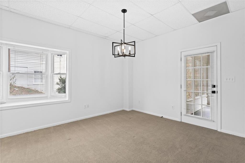 1101 Steeple Run Lawrenceville, GA 30043 - Photo 58 of 70 an empty room with windows and entrance