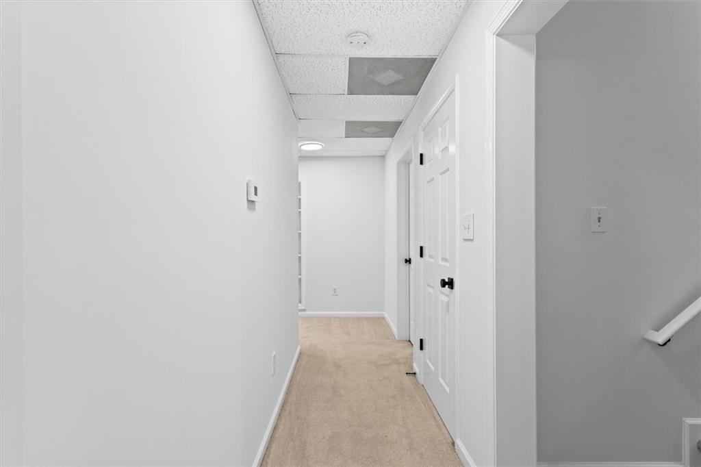 1101 Steeple Run Lawrenceville, GA 30043 - Photo 62 of 70 a view of a hallway with wooden floor and staircase