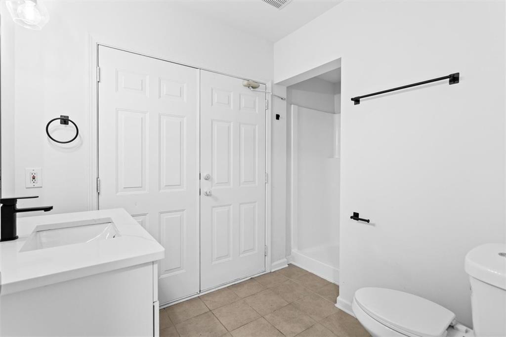 1101 Steeple Run Lawrenceville, GA 30043 - Photo 66 of 70 a bathroom with a sink a toilet and shower