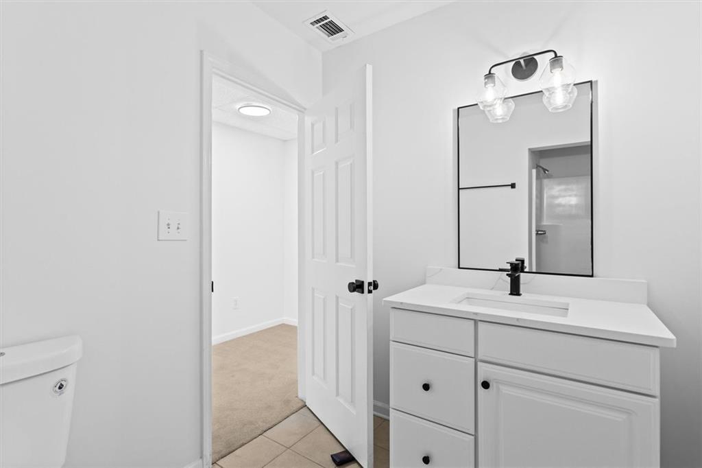 1101 Steeple Run Lawrenceville, GA 30043 - Photo 67 of 70 a bathroom with a sink vanity and a mirror