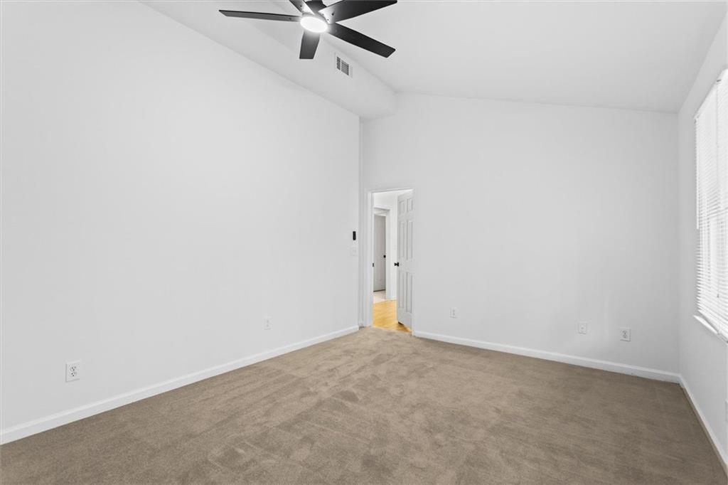 1101 Steeple Run Lawrenceville, GA 30043 - Photo 70 of 70 an empty room with a ceiling fan and window