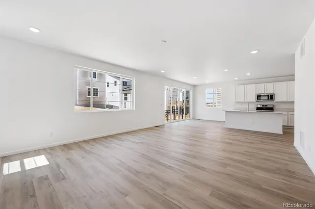 a view of kitchen and hall with wooden floor and a kitchen