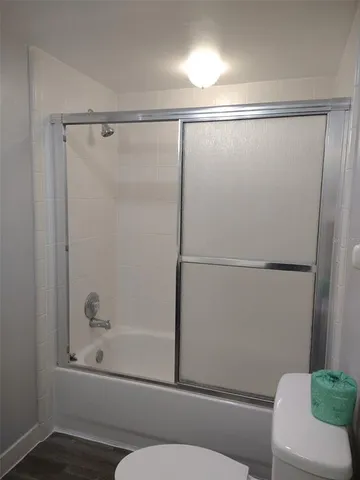 a bathroom with a shower and a toilet