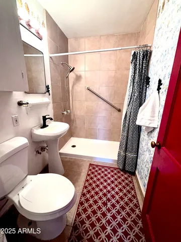 a bathroom with a sink toilet and shower