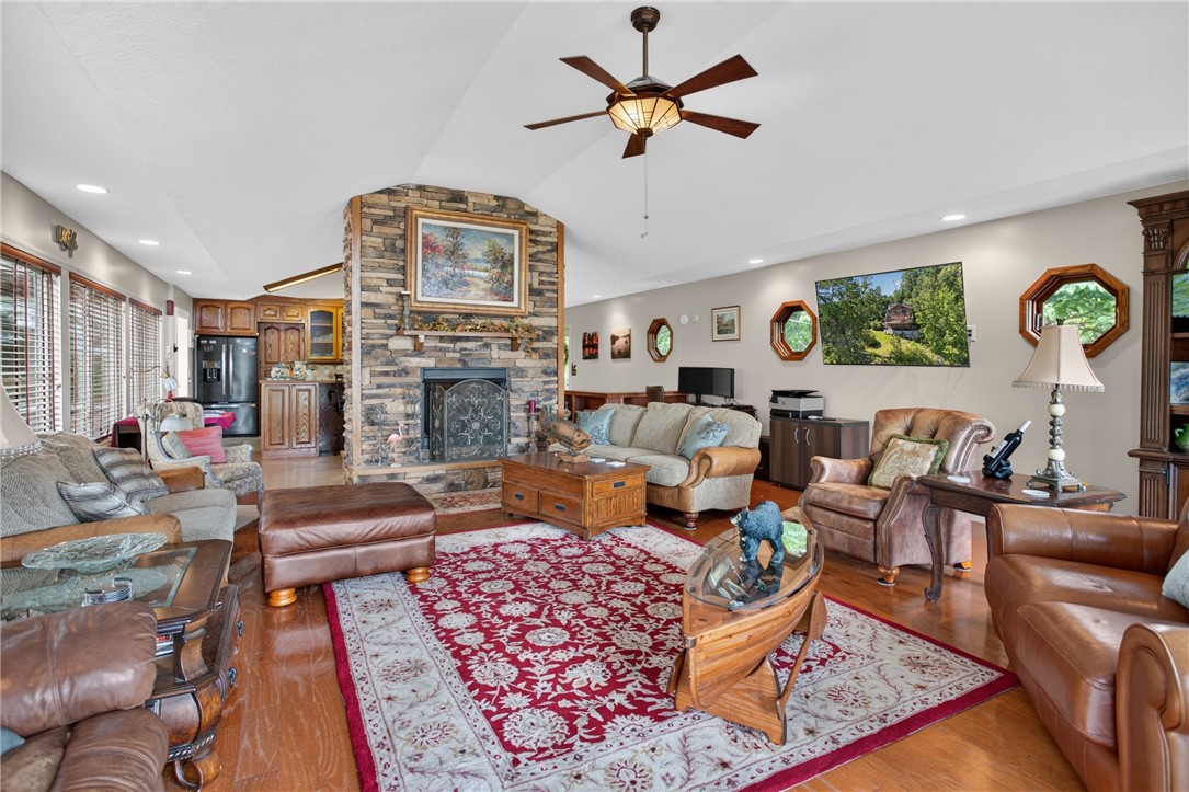 351 River Road Westminster, SC 29693 - Photo 7 of 50 A spacious living area with pretty floors, a stone fireplace, and ample natural light from numerous windows.