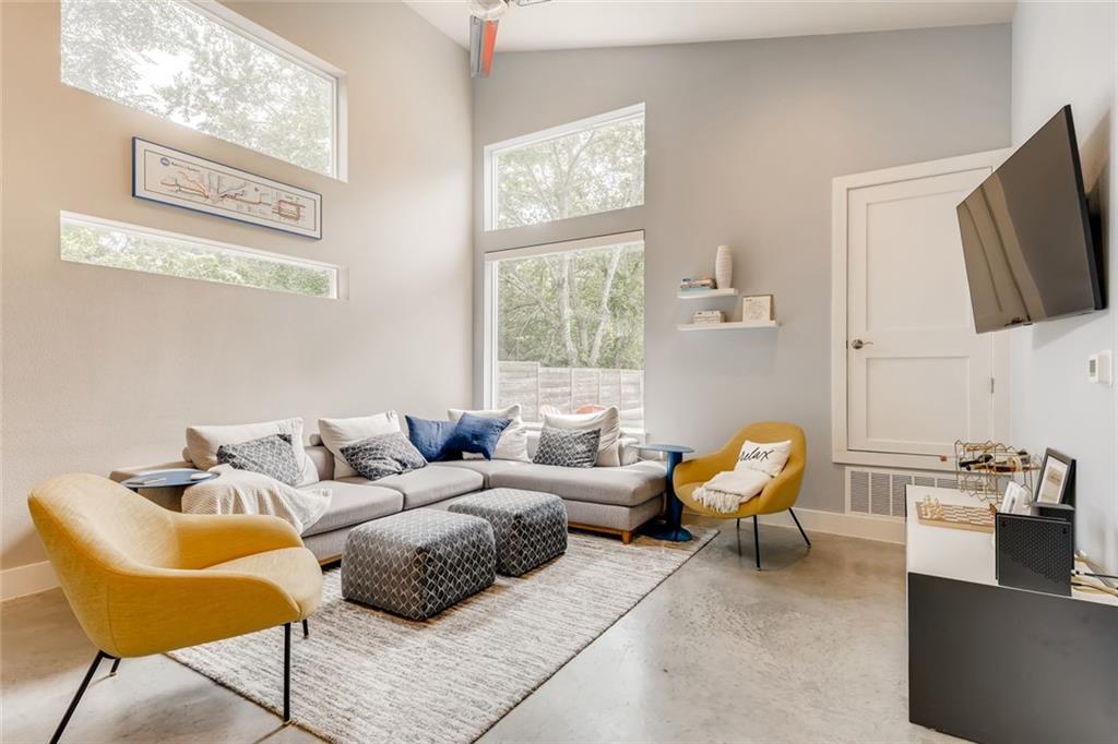 1142 Eleanor Street, Unit 2 Austin, TX 78721 - Photo 8 of 24 Concrete floors meet soaring ceilings in this contemporary living space.