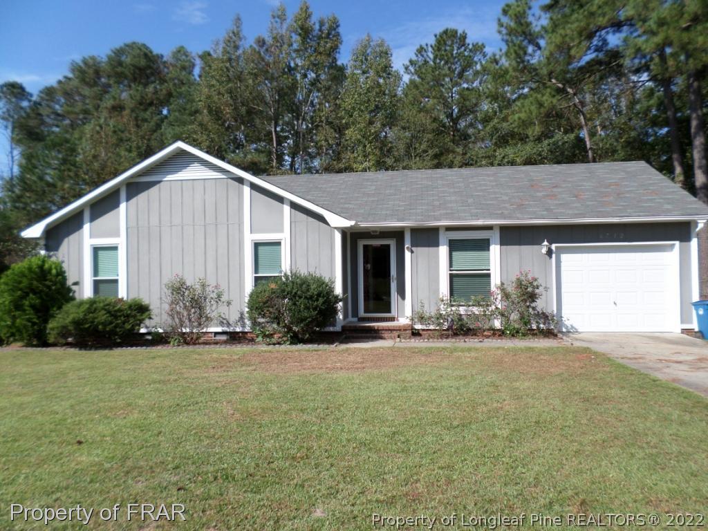 6712 Vaughn Road Fayetteville, NC 28304 - Photo 1 of 19 a front view of a house with a yard and garage