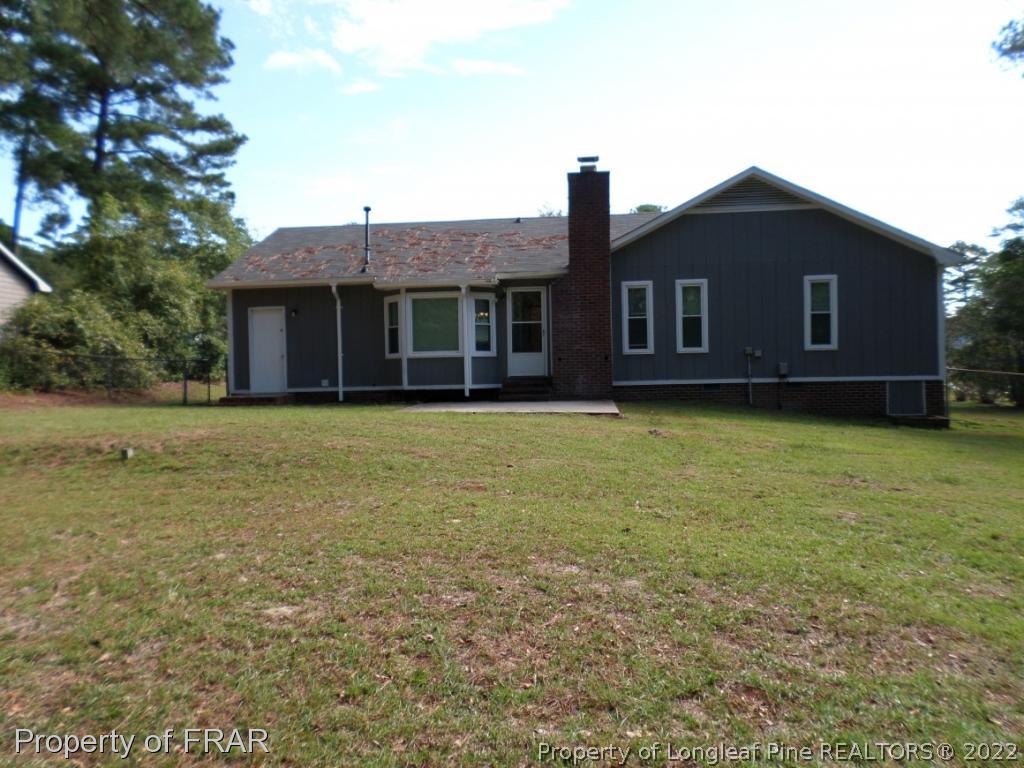 6712 Vaughn Road Fayetteville, NC 28304 - Photo 15 of 19 a front view of a house with a garden