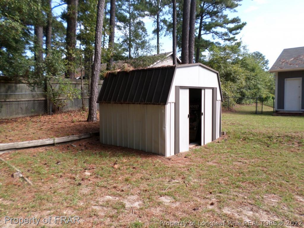 6712 Vaughn Road Fayetteville, NC 28304 - Photo 16 of 19 a backyard of a house with table and chairs