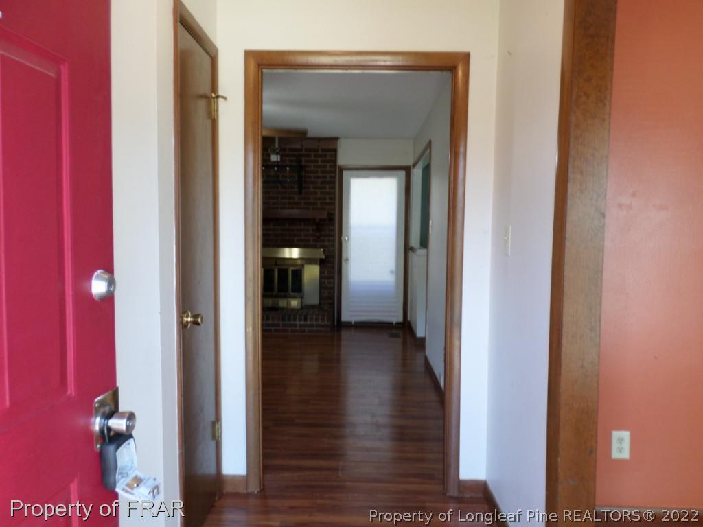 6712 Vaughn Road Fayetteville, NC 28304 - Photo 3 of 19 a view of a hallway with wooden floor and closet
