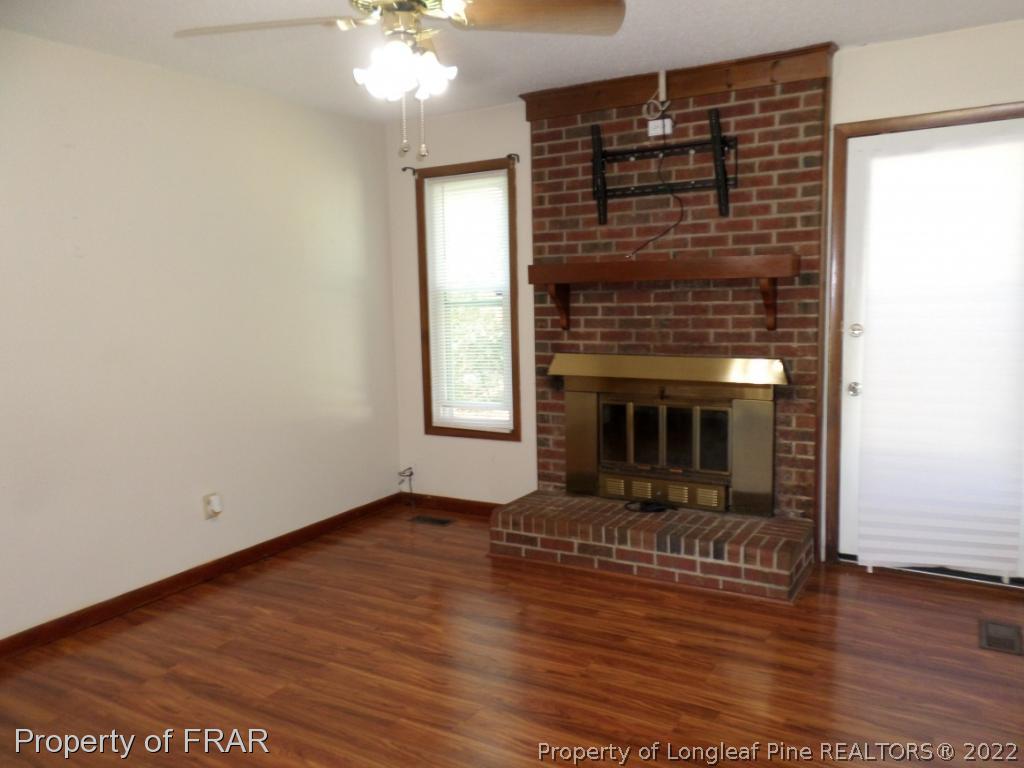 6712 Vaughn Road Fayetteville, NC 28304 - Photo 5 of 19 a view of livingroom with fireplace and window