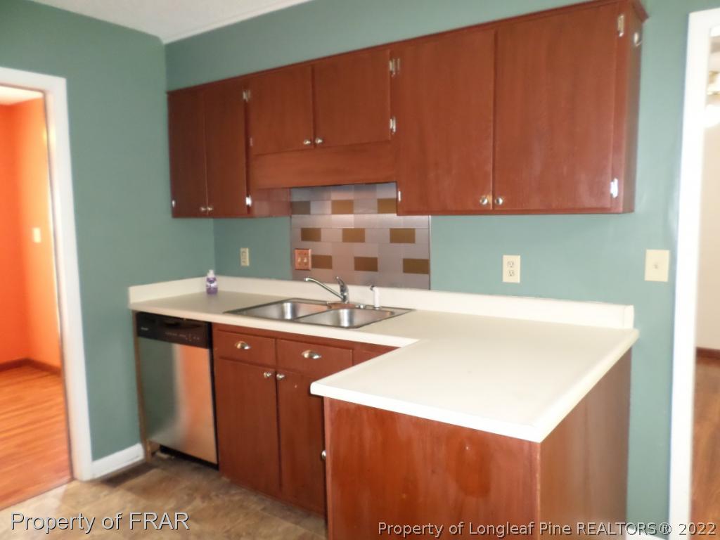 6712 Vaughn Road Fayetteville, NC 28304 - Photo 7 of 19 a kitchen with a sink cabinets and a window
