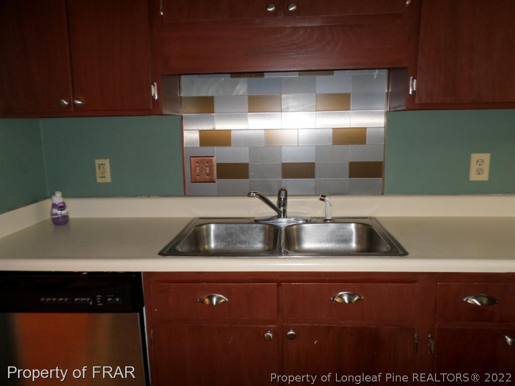 6712 Vaughn Road Fayetteville, NC 28304 - Photo 8 of 19 a kitchen with a sink and cabinets