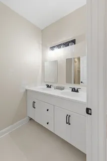 a bathroom with a double vanity sink and mirror