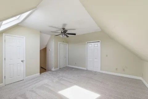 a view of a big room with closet and chandelier fan