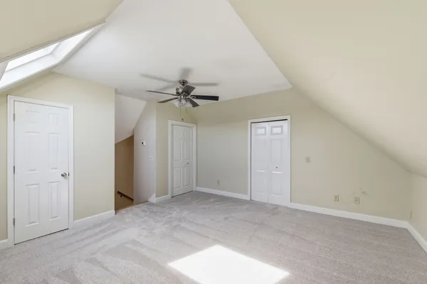 a view of a big room with closet and chandelier fan
