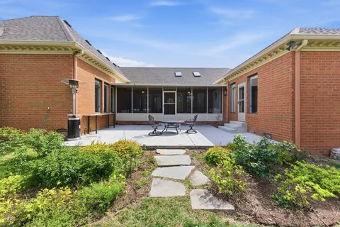a swimming pool with outdoor seating and yard