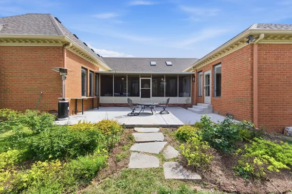 a swimming pool with outdoor seating and yard