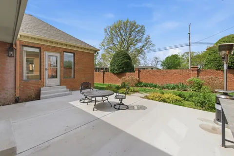 a view of a patio with a table and chairs