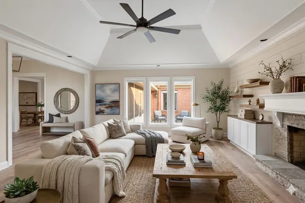 a living room with furniture fireplace and a large window