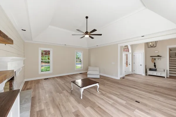 a view of room with window hardwood floor and ceiling fan