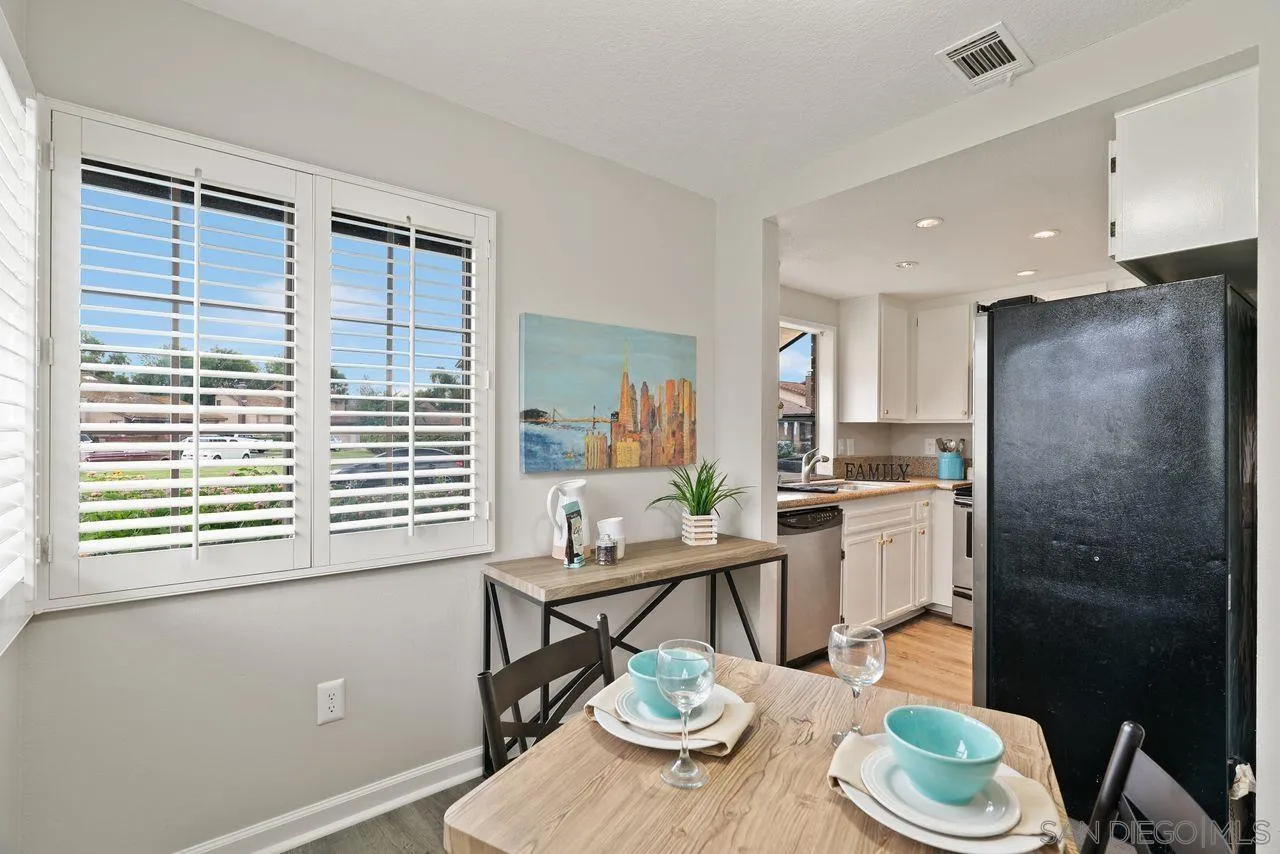 4765 Adler Way Oceanside, CA 92057 - Photo 13 of 33 a view of a dining room with furniture window and wooden floor