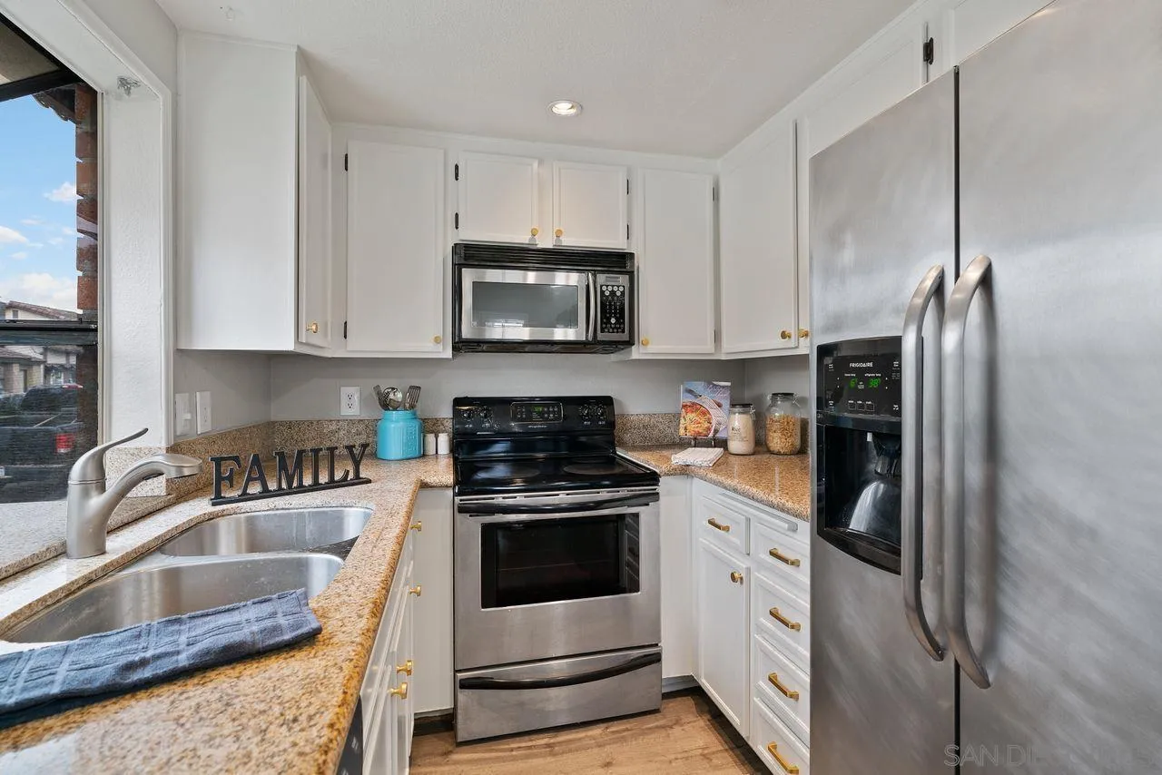 4765 Adler Way Oceanside, CA 92057 - Photo 17 of 33 a kitchen with stainless steel appliances granite countertop a refrigerator sink and stove