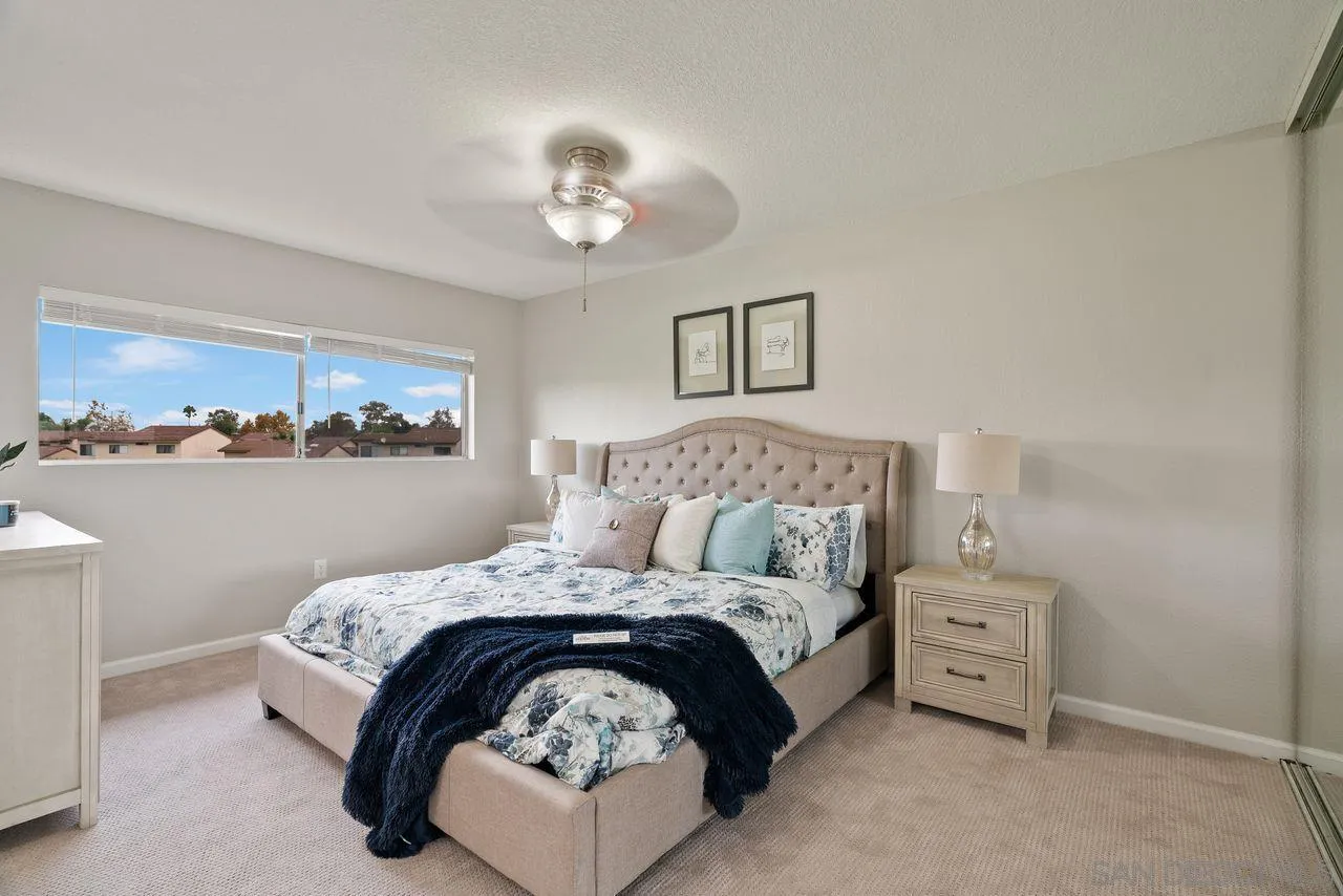 4765 Adler Way Oceanside, CA 92057 - Photo 19 of 33 a bedroom with a bed and a chandelier