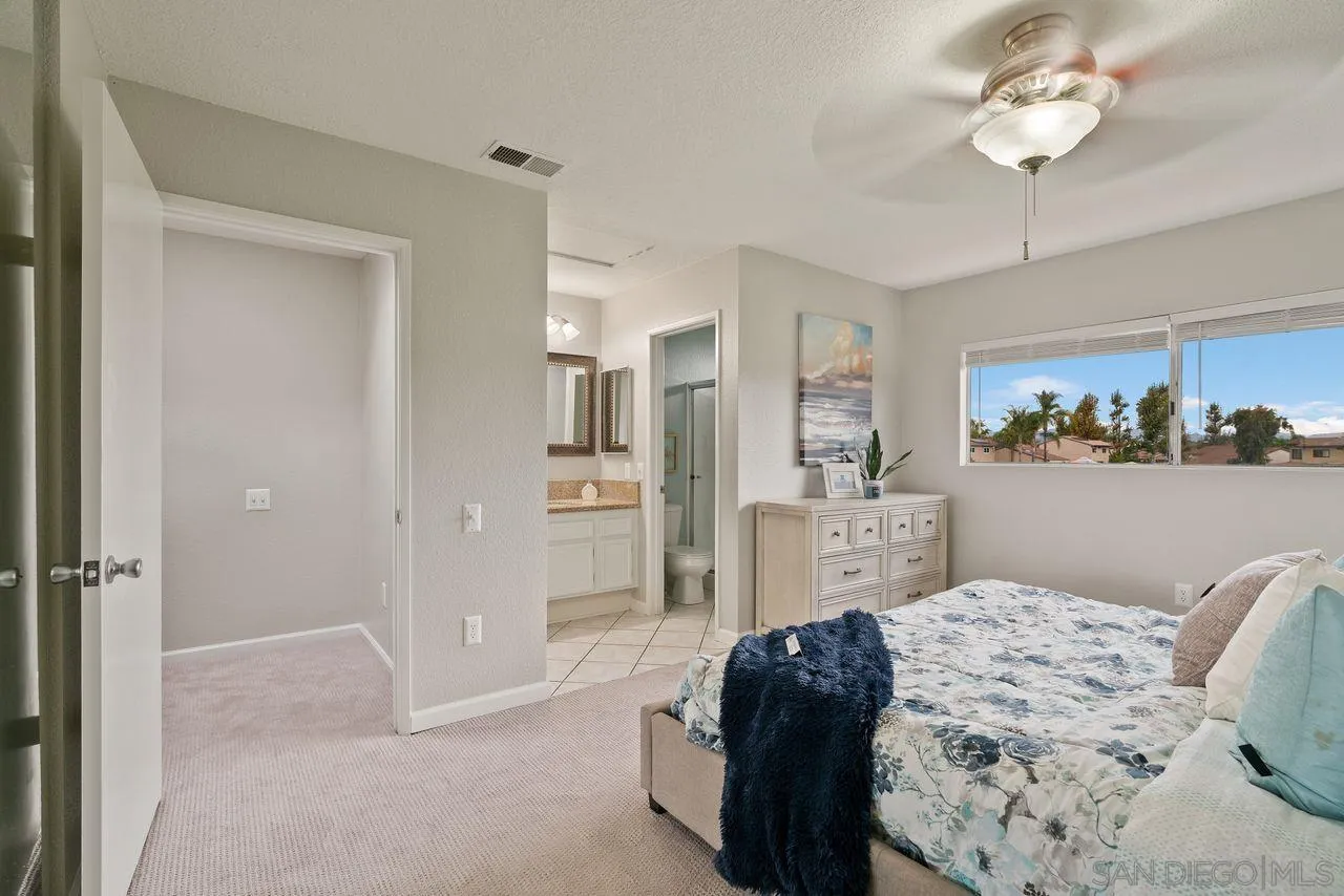4765 Adler Way Oceanside, CA 92057 - Photo 20 of 33 a bedroom with a bed dresser and window