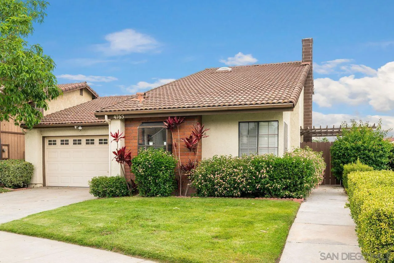 4765 Adler Way Oceanside, CA 92057 - Photo 2 of 33 a front view of a house with a yard