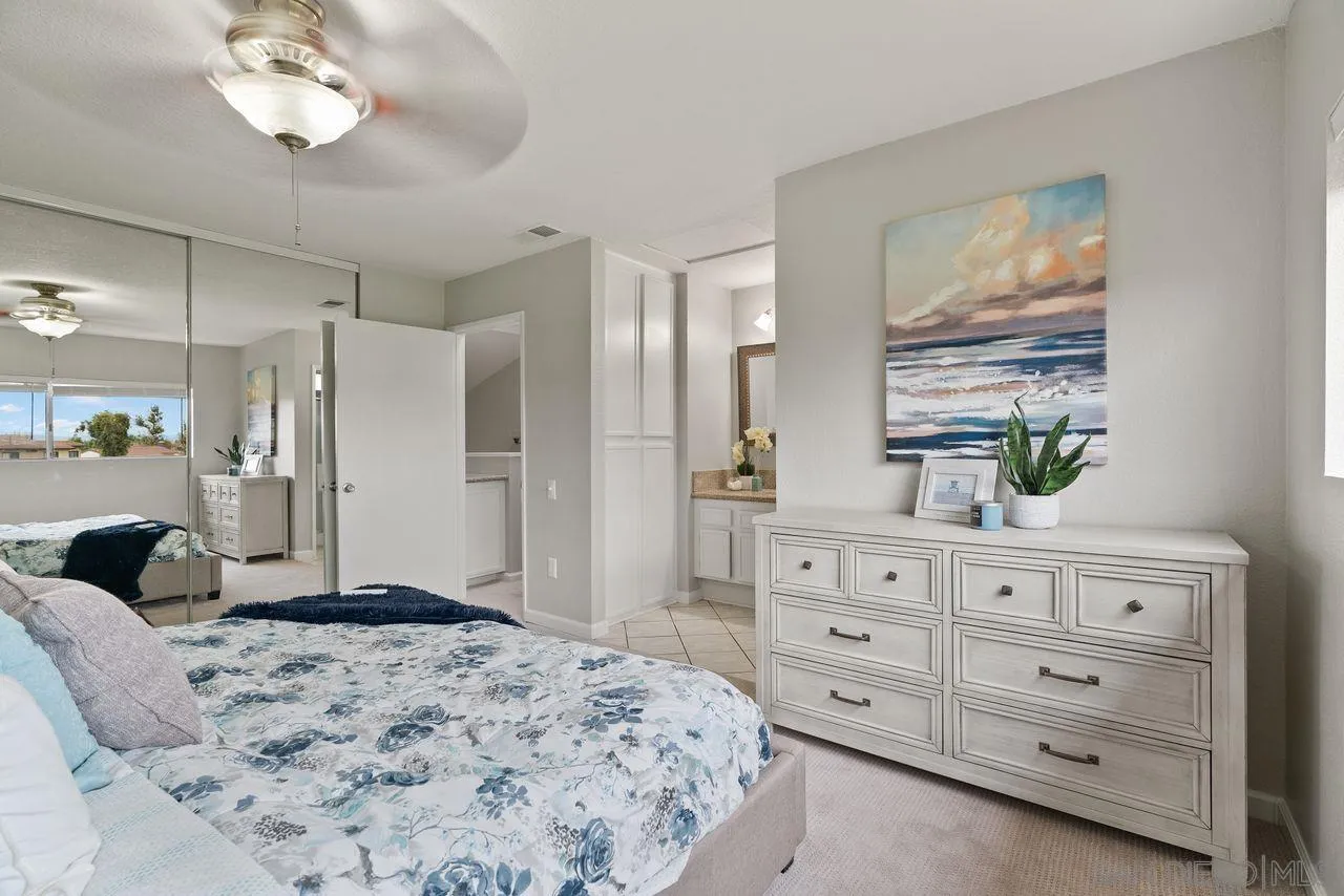 4765 Adler Way Oceanside, CA 92057 - Photo 21 of 33 a spacious bedroom with a large bed and a dresser