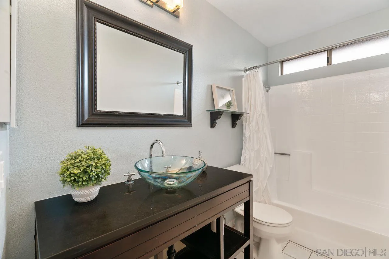 4765 Adler Way Oceanside, CA 92057 - Photo 25 of 33 a bathroom with a sink a toilet and mirror
